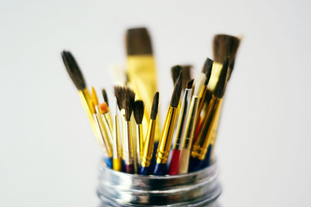 Acrylic paint brushes in a jar.