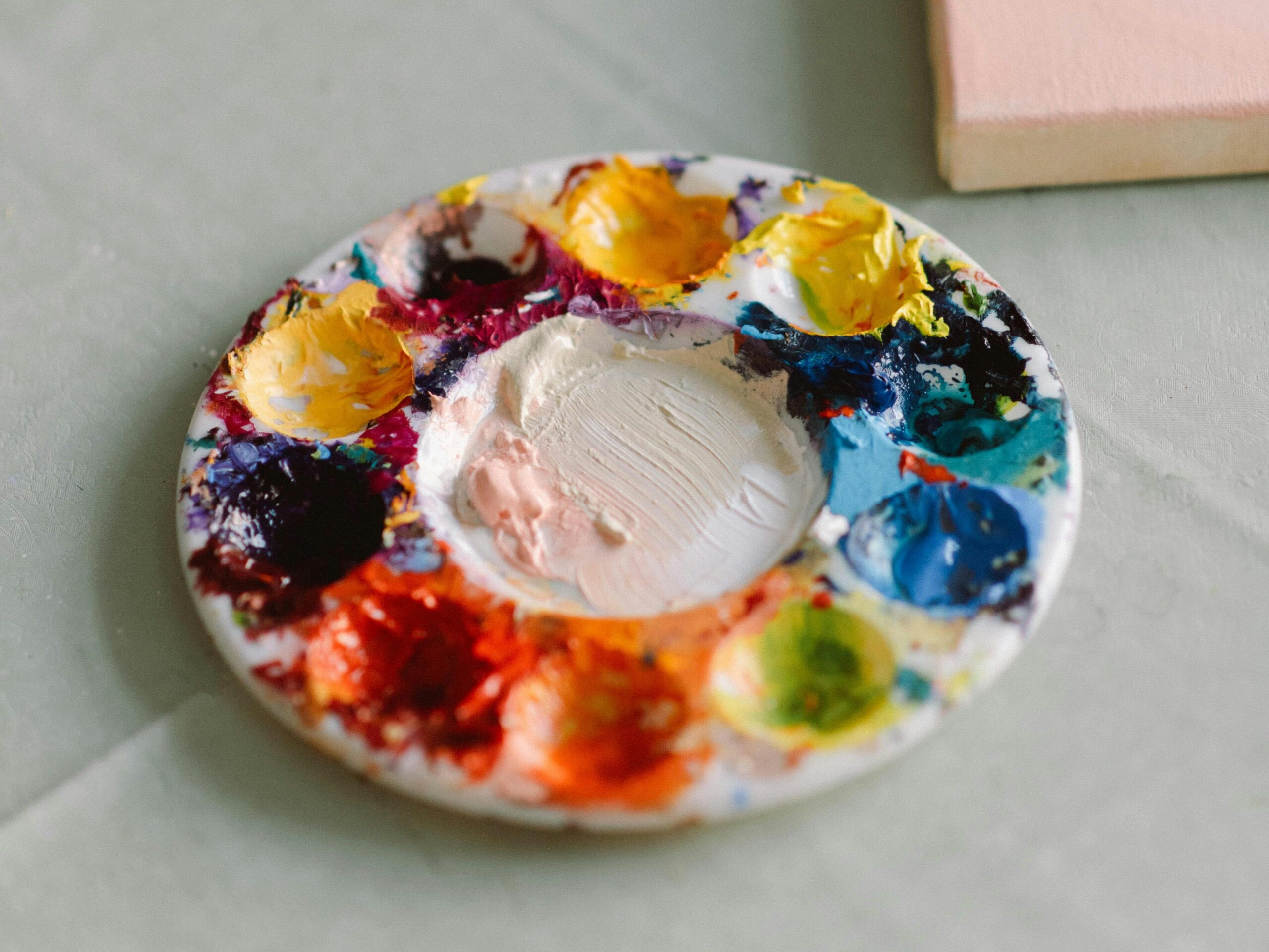 A used, messy acrylic painter's palette.